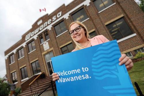 Employee Kate Urquhart stands in front of where Wawanesa Insurance began 125 years ago.