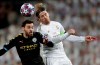 Manchester City's Bernardo Silva, left, and Real Madrid's Sergio Ramos challenge for the ball during the round of 16 first leg Champions League soccer match between Real Madrid and Manchester City at the Santiago Bernabeu stadium in Madrid, Spain, Wednesday, Feb. 26, 2020. (AP Photo/Bernat Armangue)