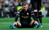 Manchester City's Aymeric Laporte sits injured on the pitch during the round of 16 first leg Champions League soccer match between Real Madrid and Manchester City at the Santiago Bernabeu stadium in Madrid, Spain, Wednesday, Feb. 26, 2020. (AP Photo/Bernat Armangue)