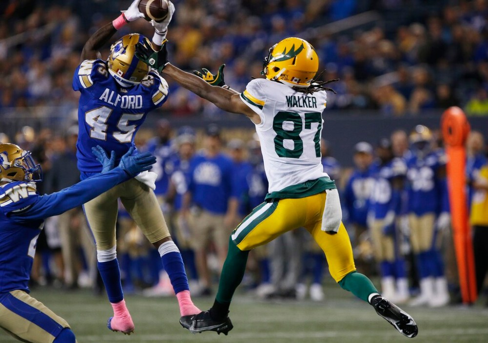 CP
DeAundre Alford intercepts a pass intended for Edmonton Elks' Derel Walker. (John Woods / The Canadian Press)