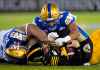 CP
Hamilton Tiger-Cats quarterback Dane Evans (9) is sacked by Winnipeg Blue Bombers defensive end Jackson Jeffcoat (94) and defensive lineman Steven Richardson (98) during the first half. (Nathan Denette / The Canadian Press)