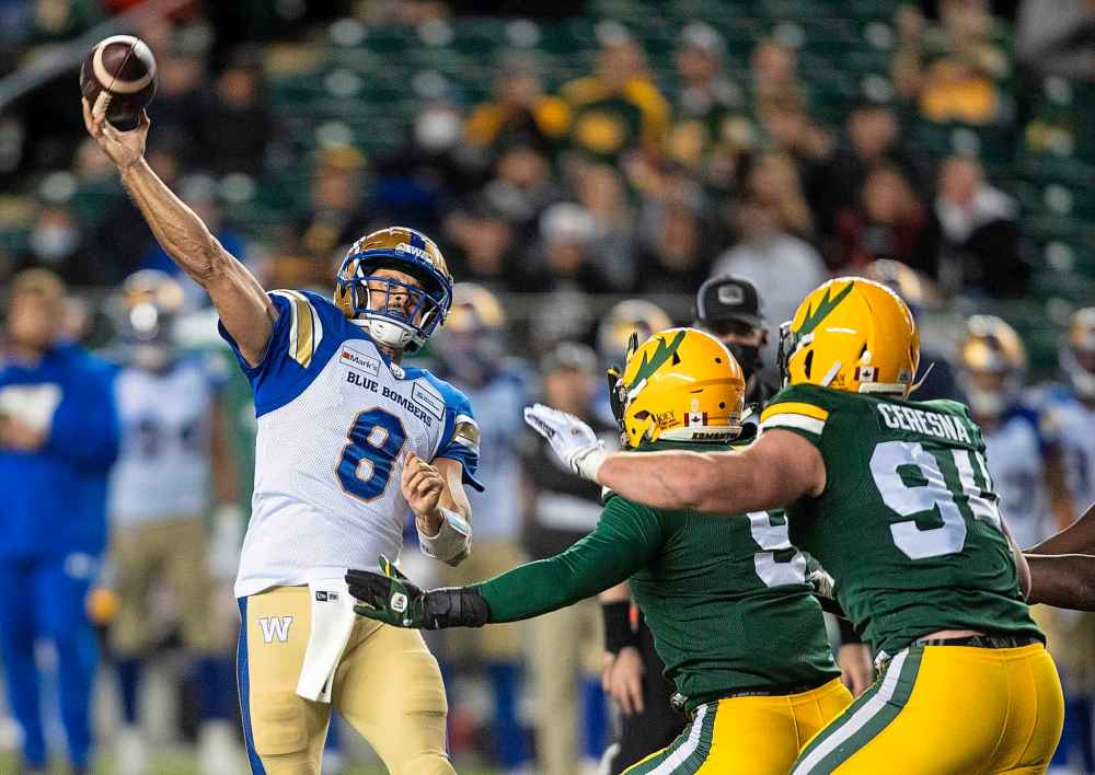 CP
Winnipeg Blue Bombers quarterback Zach Collaros (8) makes the throw against the Edmonton Elks during the first half. (Jason Franson / The Canadian Press)