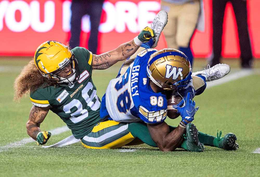 CP
Winnipeg Blue Bombers' Rasheed Bailey (88) is tackled by Edmonton Elks' Aaron Grymes (36) during the first half. (Jason Franson / The Canadian Press)