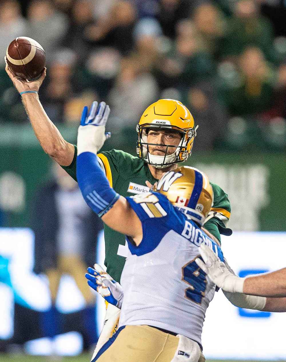 CP
Winnipeg Blue Bombers' Adam Bighill (4) tries to block Edmonton Elks quarterback Taylor Cornelius (15) during the first half. (Jason Franson / The Canadian Press)