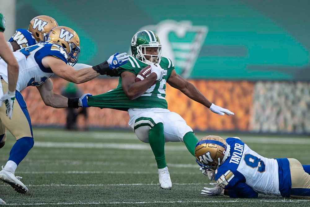 CP
Saskatchewan Roughriders running back William Powell (29) gets tackled by the Winnipeg Blue Bombers defenders during first half CFL football action in Regina, Sunday, Sept. 5, 2021. (Kayle Neis / The Canadian Press)