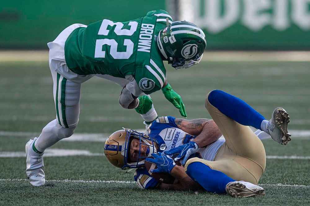 CP
Winnipeg Blue Bombers wide receiver Drew Wolitarsky (82) gets tackled while holding the ball as Saskatchewan Roughriders defensive back Blace Brown (22) tumbles over during the first half. (Kayle Neis / The Canadian Press)
