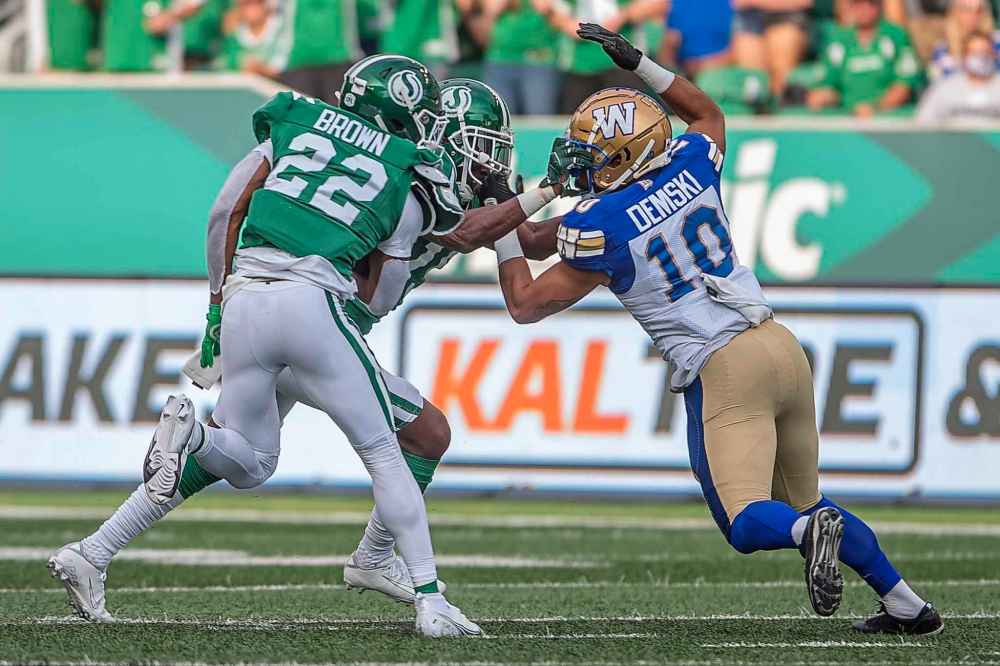 CP
Saskatchewan Roughriders safety Mike Edem (15) and Winnipeg Blue Bombers wide receiver Nic Demski (10) clash during the first half. (Kayle Neis / The Canadian Press)