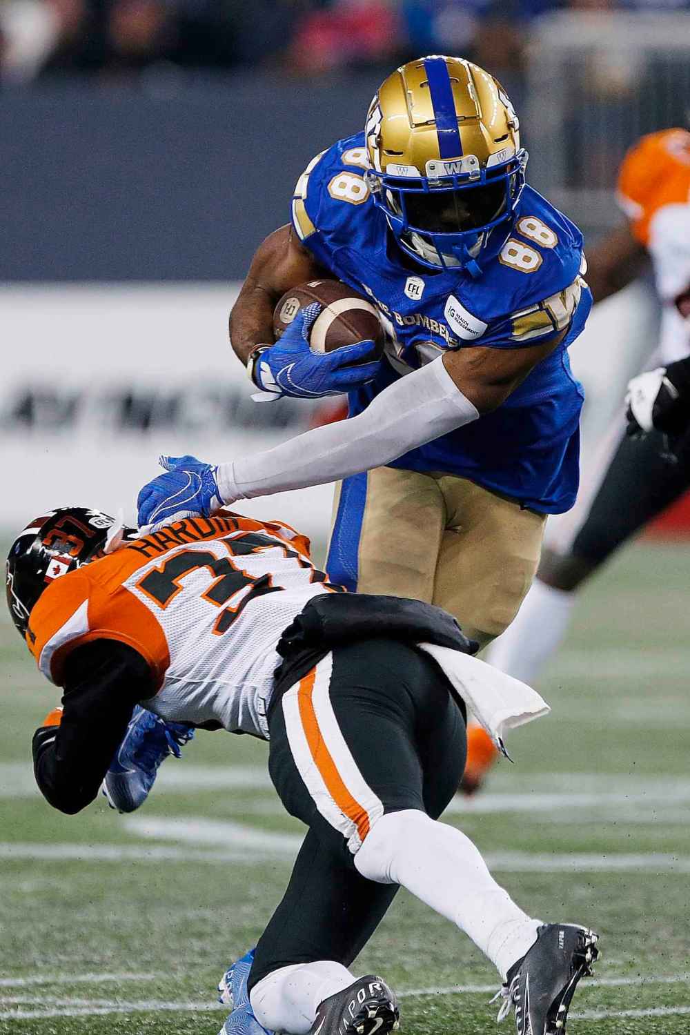 CP
Winnipeg Blue Bombers' Rasheed Bailey (88) attempts to get around B.C. Lions' KiAnte Hardin (37) as he gets the first down during the first half. (John Woods / The Canadian Press)