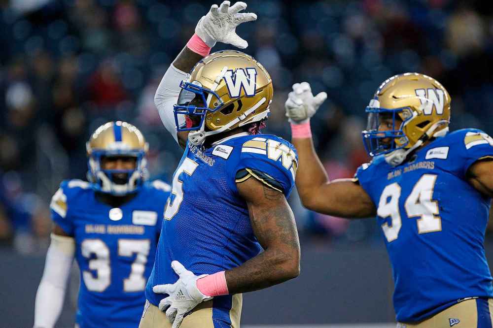 CP
Winnipeg Blue Bombers' Willie Jefferson (5) and Jackson Jeffcoat (94) celebrate their sack of B.C. Lions quarterback Mike Reilly (not shown) during the first half of CFL action in Winnipeg Saturday, October 23, 2021. (John Woods / The Canadian Press)