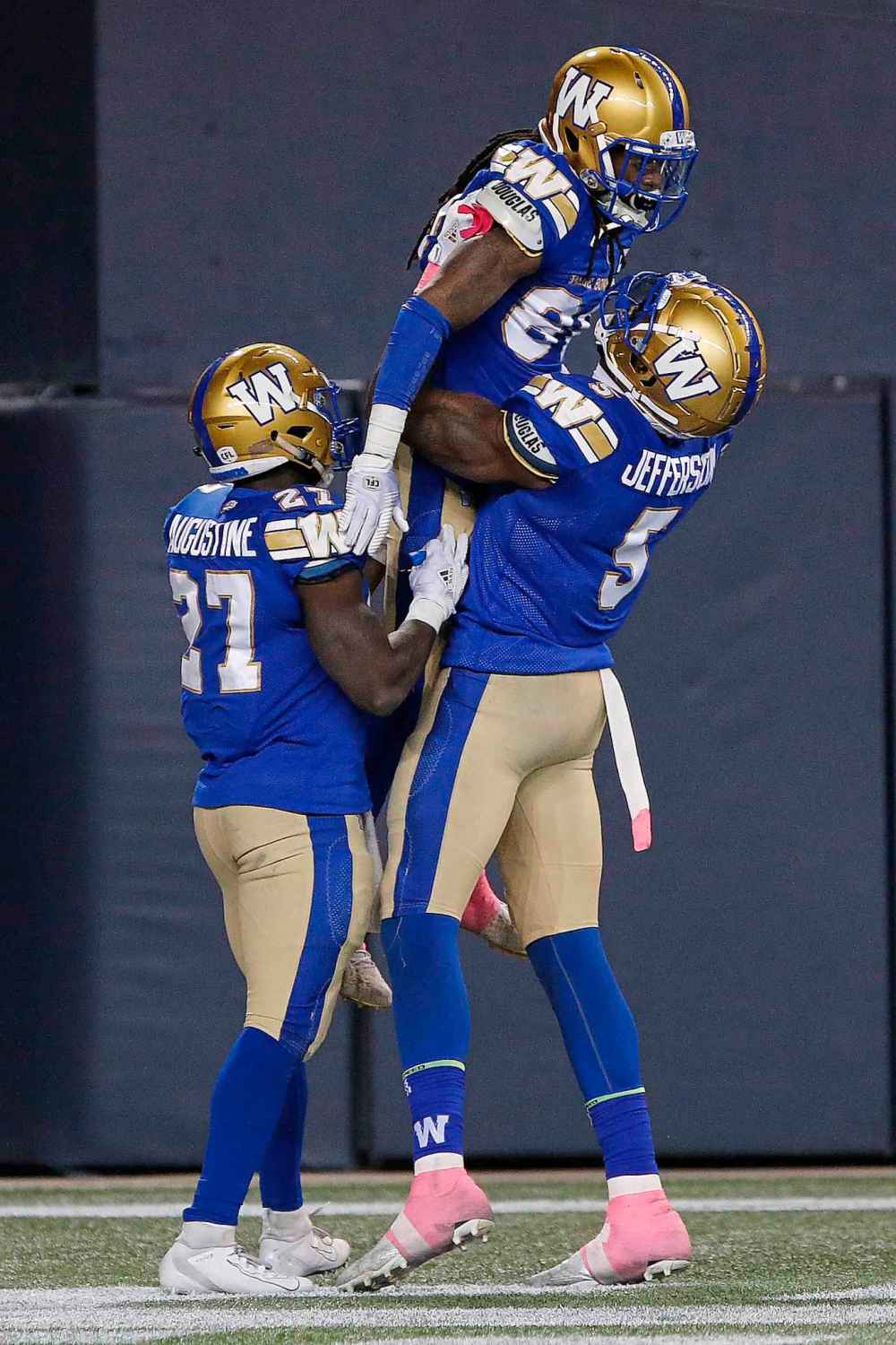 CP
Winnipeg Blue Bombers' Johnny Augustine (27) and Willie Jefferson (5) celebrate Janarion Grant's (80) punt return touchdown against the B.C. Lions during the second half. (John Woods / The Canadian Press)