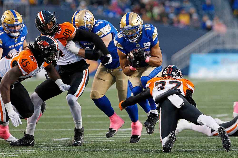 CP
Winnipeg Blue Bombers' Nic Demski (10) goes for the first down against B.C. Lions' KiAnte Hardin (37) during the first half. (John Woods / The Canadian Press)