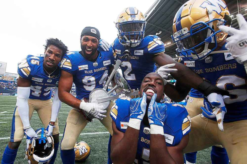 CP
Winnipeg Blue Bombers' DeAundre Alford (45), Jackson Jeffcoat (94), Jonathan Kongbo (2), Tobi Antigha (15) and Jontrell Rocquemore (36) celebrate their Banjo Bowl win over the Roughriders. (John Woods / The Canadian Press)