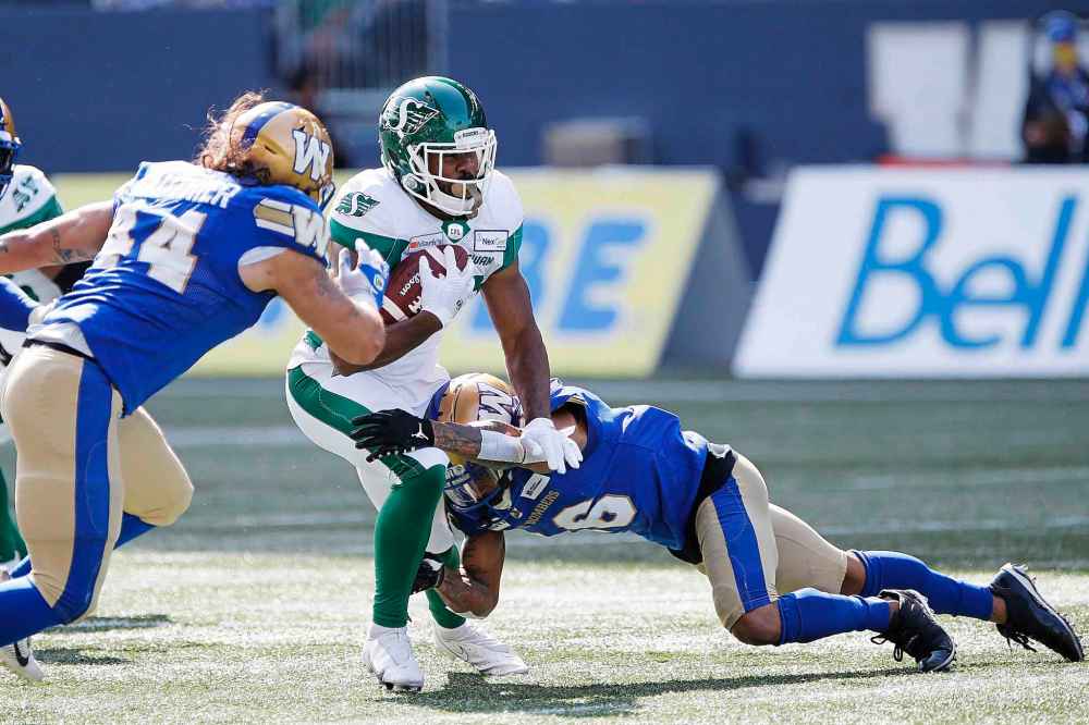 CP
Winnipeg Blue Bombers' Mike Jones (16) tackles Saskatchewan Roughriders' William Powell (29) during first half. (John Woods / The Canadian Press)