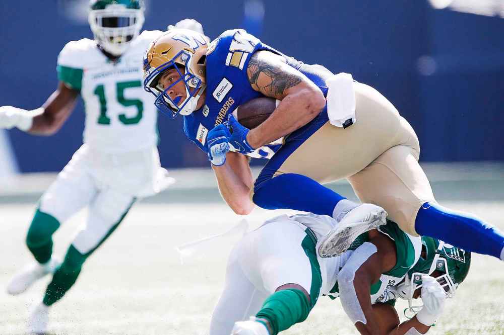 CP
Winnipeg Blue Bombers' Drew Wolitarsky (82) gets tackled by a Saskatchewan Roughrider during first half. (John Woods / The Canadian Press)