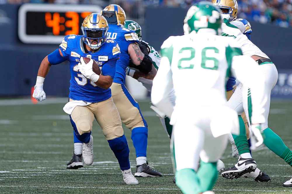 CP
Winnipeg Blue Bombers' Andrew Harris (33) runs for the first down against the Saskatchewan Roughriders during first half. (John Woods / The Canadian Press)