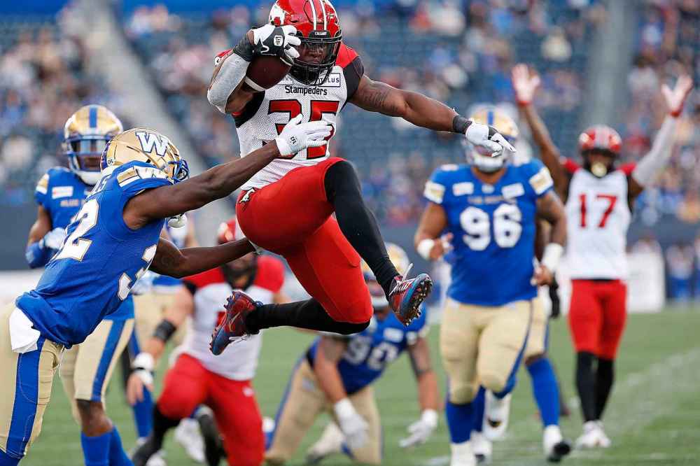 CP
Winnipeg Blue Bombers' Deatrick Nichols (32) can’t stop Calgary Stampeders' Ka'Deem Carey (35) as he leaps in for the touchdown during the first half. (John Woods / The Canadian Press)