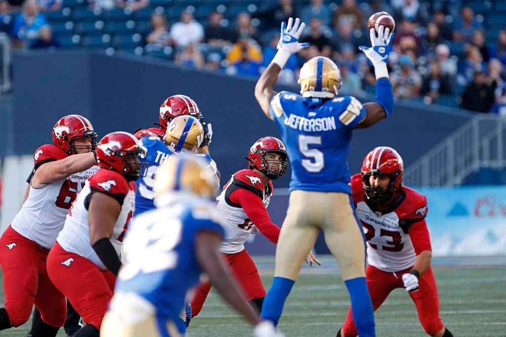 CP
Winnipeg Blue Bombers' Willie Jefferson (5) blocks the throw by Calgary Stampeders quarterback Jake Maier (12) during the first half. (John Woods / The Canadian Press)