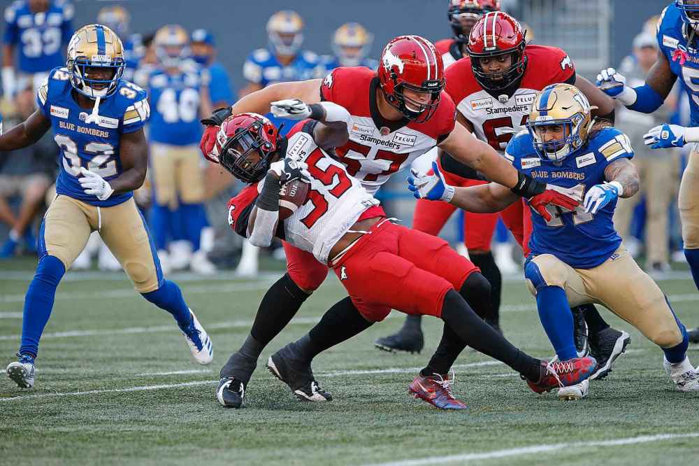 THE CANADIAN PRESS
Calgary Stampeders’ Ka'Deem Carey (35) dives for the first down against the Winnipeg Blue Bombers during the first half. (John Woods / The Canadian Press)