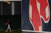 Boston Red Sox bullpen coach Kevin Walker strolls out to the field during spring training baseball practice on Monday, Feb. 22, 2021, in Fort Myers, Fla. (AP Photo/Brynn Anderson)