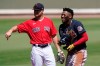 Boston Red Sox's Christian Arroyo, left, laughs with Atlanta Braves' Ronald Acuna Jr., right, in the first inning during a spring training baseball game on Monday, March 1, 2021, in Fort Myers, Fla. (AP Photo/Brynn Anderson)