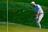 Chris Kirk chips to the green on the ninth hole during the second round of the The Players Championship golf tournament Friday, March 12, 2021, in Ponte Vedra Beach, Fla. (AP Photo/John Raoux)