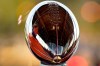 A man looks at the Lombardi Trophy at the NFL Experience Thursday, Feb. 4, 2021, in Tampa, Fla. The city is hosting Sunday's Super Bowl football game between the Tampa Bay Buccaneers and the Kansas City Chiefs. (AP Photo/Charlie Riedel)