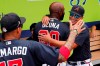 Atlanta Braves' Marcell Ozuna hugs Martin Prado, right, in the dugout before a spring training baseball game against the Tampa Bay Rays, Tuesday, March 3, 2020, in Venice, Fla. (AP Photo/Elise Amendola)