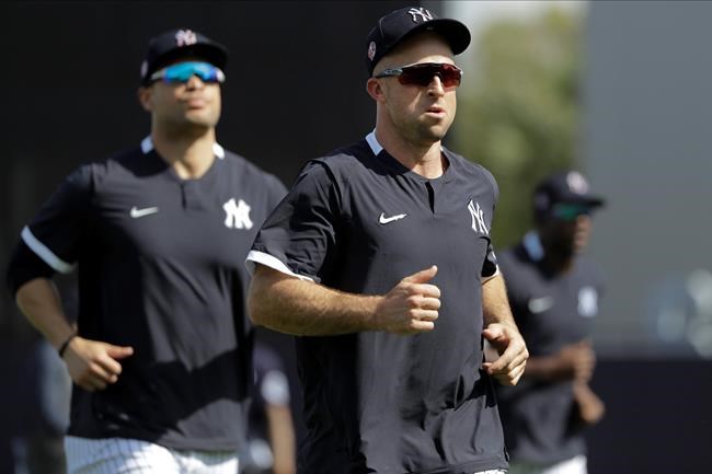 New York Yankees' Brett Gardner, center, and Giancarlo Stanton, left, run on the field during a spring training baseball workout Tuesday, Feb. 18, 2020, in Tampa, Fla. (AP Photo/Frank Franklin II)