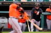 Baltimore Orioles manager Brandon Hyde, right, stands in the dugout steps as Yolmer Sanchez bats during the fourth inning of a spring training exhibition baseball game against the Pittsburgh Pirates in Bradenton, Fla., Monday, March 22, 2021. (AP Photo/Gene J. Puskar)