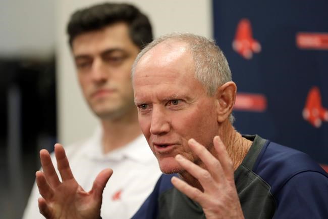 Ron Roenicke, right, speaks as Red Sox Chief Baseball Officer Chaim Bloom looks on after being after being named interim of the Boston Red Sox baseball team Tuesday, Feb. 11, 2020, in Fort Myers, Fla. at left. (AP Photo/John Bazemore)