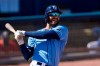 Tampa Bay Rays center fielder Kevin Kiermaier (39) reacts after fouling a ball off his foot during the sixth inning of a spring training baseball game Saturday, March 13, 2021, in Port Charlotte, Fla.. (AP Photo/John Bazemore)