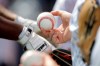 A fan holds a baseball while waiting for an autograph fro New York Yankees infielder Chris Gittens prior to a spring training baseball game against the Washington Nationals, Thursday, March 12, 2020, in West Palm Beach, Fla. (AP Photo/Julio Cortez)