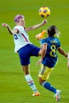 United States forward Megan Rapinoe, left tries to control the ball as she gets in front of Colombia midfielder Jessica Caro (8) during the first half of an international friendly soccer match, Monday, Jan. 18, 2021, in Orlando, Fla. (AP Photo/John Raoux)