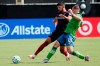 Chicago Fire defender Mauricio Pineda, left, and Seattle Sounders forward Jordan Morris (13) fight for position on the ball during the second half of an MLS soccer match, Tuesday, July 14, 2020, in Kissimmee, Fla. (AP Photo/John Raoux)