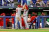 Los Angeles Angels' Jose Iglesias (4) congratulates Mike Trout after his solo home run against the Toronto Blue Jays during the fifth inning of a baseball game Thursday, April 8, 2021, in Dunedin, Fla. (AP Photo/Mike Carlson)