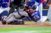 Atlanta Braves catcher Travis d'Arnaud tags out Toronto Blue Jays' Randal Grichuk during the sixth inning of a baseball game Saturday, May 1, 2021, in Dunedin, Fla. (AP Photo/Mike Carlson)