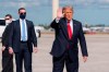 Former President Donald Trump waves to the members of the media on arrival at Palm Beach International Airport in West Palm Beach, Fla., Wednesday, Jan. 20, 2021. (AP Photo/Manuel Balce Ceneta)