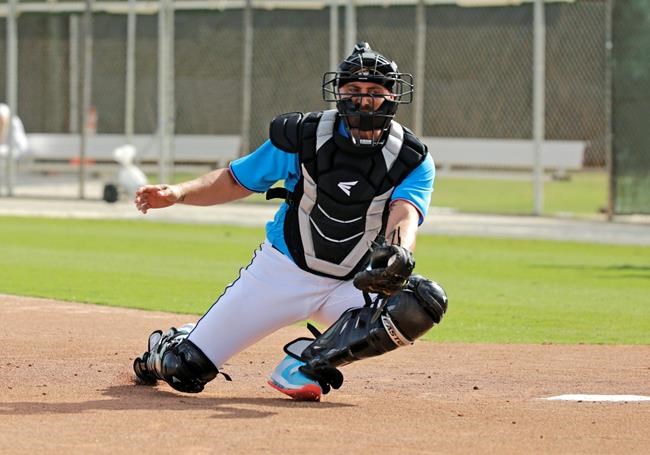 FILE - In this Feb. 12, 2020, file photo, Miami Marlins catcher Francisco Cervelli run drills during a spring training baseball workouts for pitchers and catchers at Roger Dean Stadium in Jupiter, Fla. Cervelli says he’s fully recovered from his latest concussion, and Jorge Alfaro says he’s feeling fitter after an offseason spent working on the farm and running sprints. At catcher, at least, the Miami Marlins appear in good shape. (David Santiago/Miami Herald via AP, File)