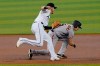 Miami Marlins third baseman Brian Anderson tags San Francisco Giants' Mike Yastrzemski (5) during the first inning of a baseball game, Sunday, April 18, 2021, in Miami. (AP Photo/Marta Lavandier)