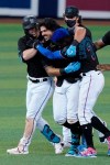 Miami Marlins' Jorge Alfaro, center, is congratulated after he hit a double in the 10th inning to drive in the winning run in the team's baseball game against the San Francisco Giants, Saturday, April 17, 2021, in Miami. The Marlins won 7-6. (AP Photo/Marta Lavandier)