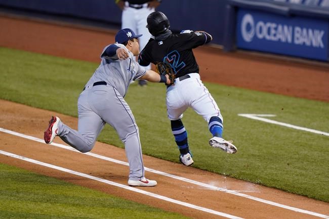 Tampa Bay Rays first baseman Ji-Man Choi, left, tags out Miami Marlins' Jon Berti along the first-base line during the first inning of a baseball game, Saturday, Aug. 29, 2020, in Miami. (AP Photo/Wilfredo Lee)