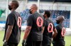 Members of all the MLS soccer teams march around the stadium before a match Wednesday, July 8, 2020, in Kissimmee, Fla., while wearing shirts and masks with messages about race. (AP Photo/John Raoux)