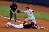 Philadelphia Phillies first baseman Rhys Hoskins (17) puts out Miami Marlins' Corey Dickerson, bottom, at first after Marlins' Starling Marte lined out into a double play during the first inning of a baseball game, Saturday, Sept. 12, 2020, in Miami. (AP Photo/Wilfredo Lee)