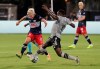 New England Revolution midfielder Kelyn Rowe, left, and Montreal Impact midfielder Victor Wanyama vie for the ball during the first half of an MLS soccer match Thursday, July 9, 2020, in Kissimmee, Fla. (AP Photo/John Raoux)