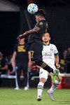 Los Angeles FC forward Latif Blessing (7) wins a header in front of Portland Timbers midfielder Sebastian Blanco during the first half of an MLS soccer match, Thursday, July 23, 2020, in Kissimmee, Fla. (AP Photo/Phelan M. Ebenhack)