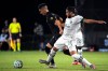 Los Angeles FC midfielder Eduard Atuesta, left, and Portland Timbers defender Bill Tuiloma (25) compete for a ball during the second half of an MLS soccer match, Thursday, July 23, 2020, in Kissimmee, Fla. (AP Photo/Phelan M. Ebenhack)