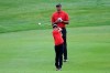 Tiger Woods watches his son Charlie's shot from the third fairway during the final round of the PNC Championship golf tournament, Sunday, Dec. 20, 2020, in Orlando, Fla. (AP Photo/Phelan M. Ebenhack)