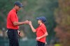 Tiger Woods, left, shares a fist-bump with his son Charlie after putting on the 18th green during the final round of the PNC Championship golf tournament, Sunday, Dec. 20, 2020, in Orlando, Fla. (AP Photo/Phelan M. Ebenhack)