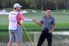 Collin Morikawa, right, is congratulated by his caddie J.J. Jakovac after putting on the 18th green to win the Workday Championship golf tournament Sunday, Feb. 28, 2021, in Bradenton, Fla. (AP Photo/Phelan M. Ebenhack)