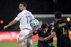 LA Galaxy midfielder Sebastian Lletget (17) competes for the ball with Los Angeles FC midfielder Eduard Atuesta (20) and defender Eddie Segura (4) during the first half of an MLS soccer match Saturday, July 18, 2020, in Kissimmee, Fla. (AP Photo/Phelan M. Ebenhack)
